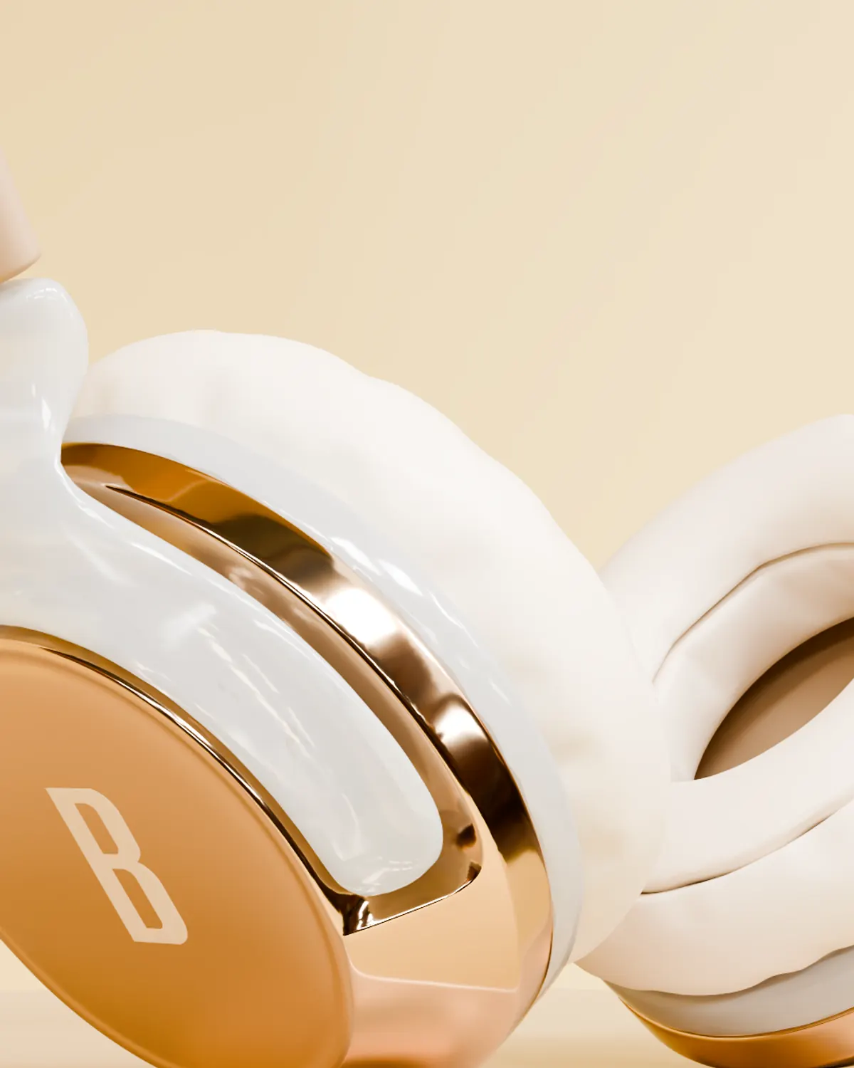 Close view of the rose gold earcup plate with the embossed B and the white cushion behind it